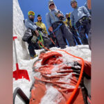The Indian Army’s High Altitude Warfare School (HAWS) has successfully recovered the remains of three soldiers lost in a tragic mountaineering accident last year. The special mission, codenamed Operation RTG, concluded on July 8, nearly nine months after the initial incident. The operation was launched to retrieve the bodies of Havildar Rohit Kumar, Havildar Thakur Bahadur Ale, and Naik Gautam Rajbanshi, who were part of a 38-member HAWS expedition to Mount Kun in Ladakh. On October 8, 2023, the team was struck by a sudden avalanche at an altitude of over 18,300 feet, resulting in the loss of four members. While one body was recovered immediately, the other three remained trapped in a deep crevasse. Refusing to abandon their fallen comrades, HAWS initiated Operation RTG on June 18, 2024. The mission involved 88 expert mountaineers who faced extreme weather conditions and treacherous terrain. Led by Brigadier SS Shekhawat, Deputy Commandant of HAWS, the team established multiple camps and used advanced equipment to conduct their search. A road head camp was established about 40 kms short of Khumbathang, for deposition of specialised mountaineering and rescue equipment, special clothing, survival kits, tents, meals, etc. Two helicopters were also placed on standby to ferry the mortal remains of the bravehearts and for evacuation of rescue team, if need be. A Base Camp was established at a distance of approximately 13 Kms from the road head at a height of about 14790ft. Maj Gen Bruce Fernandez, Commandant, HAWS, stationed himself at Base Camp, overseeing the rescue efforts. After weeks of grueling effort, the team made a breakthrough on July 4, when the mortal remains of Havildar Rohit Kumar (Dogra Scouts) were found about 30 ft of a snow and ice in the crevasse. The mortal remains were transported to Kumbathang by helicopter. With renewed resolve, the team, braving challenges posed by extremities of cold and terrain, went 10 ft deeper in the crevasse, where mortal remains of Havildar Thakur Bahadur Ale (Gorkha Rifles) was recovered on 7 July. Mission aim was finally accomplished on 8 July, as the mortal remains of all three trapped soldiers were recovered and no Team Member was left behind. The mortal remains have been transported to respective families, with full military honours.