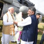 PM Modi Arrives In Mysuru, Received By Karnataka CM Shivakumar Ahead Of Viveka Smaraka Inauguration PM Modi Arrives in Mysuru, Received by Karnataka CM Shivakumar Ahead of Viveka Smaraka Inauguration Prime Minister Narendra Modi arrived in Mysuru on Saturday to inaugurate the Swami Vivekananda Cultural Youth Centre (Viveka Smaraka) at the Ramakrishna Ashrama, where he was received by Karnataka Chief Minister D.K. Shivakumar and Governor Thaawarchand Gehlot. The Chief Minister welcomed the Prime Minister at the Mysuru helipad by presenting him with a shawl and a bouquet before the two leaders proceeded to the inauguration venue. The Prime Minister is scheduled to inaugurate the Viveka Smaraka, a memorial established to commemorate Swami Vivekananda’s historic visit to Mysuru in 1892 during his journey across India, prior to his landmark address at the Parliament of the World’s Religions in Chicago in 1893. Following the inauguration, PM Modi will visit the Ramakrishna Ashrama School before departing for New Delhi from Mysuru Airport on a special aircraft. Ahead of the Prime Minister’s visit, Mysuru was placed under extensive security cover, with authorities enforcing stringent security measures and traffic restrictions across the city. More than 1,000 police personnel have been deployed under the supervision of South Zone Inspector General of Police M.B. Boralingaiah. The security arrangement includes one Superintendent of Police, one Police Commissioner, four Additional Superintendents of Police, 18 Police Inspectors, 40 Sub-Inspectors, 550 male police personnel, 350 women police personnel and 250 Home Guards. Security has been intensified around the Ramakrishna Ashrama, Oval Grounds, Mysuru Airport, and along the Prime Minister’s convoy route. Authorities have also restricted traffic on 12 major roads in the city to facilitate VVIP movement and ensure security during the visit.